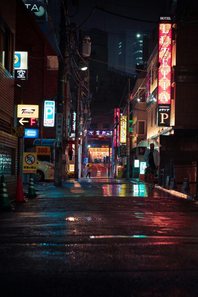 Explore the vibrant and illuminated neon streets of Tokyo at night, capturing the dynamic energy of the urban landscape.